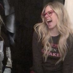 two women laughing while sitting next to each other