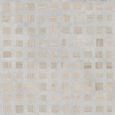 an area rug made out of wood strips on top of cement flooring with white and beige colors