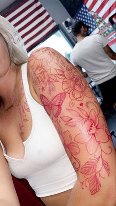 a woman with tattoos on her arm and shoulder