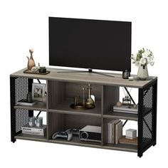 an entertainment center with shelves and a flat screen tv mounted on it's side