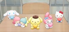 several stuffed animals sitting on top of a wooden table