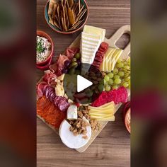 a wooden table topped with lots of different types of cheese and meats on top of it