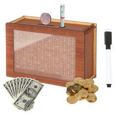 a wooden box filled with money next to a pen and some coins in front of it