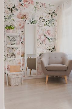 a living room with floral wallpaper and a chair in front of a mirror on the wall