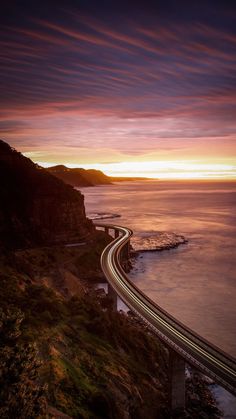 a highway going over the ocean at sunset