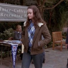 a woman standing in front of an inner - college recruiting fair with her hands on her hips