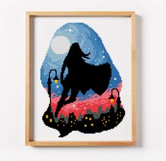 a cross - stitch picture of a cow in the moonlight