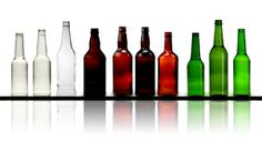 there are many different colored bottles lined up