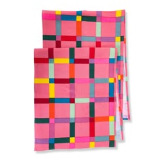 two pieces of pink, green, and yellow colored paper with squares on the side