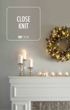 a mantle with candles and a wreath on it that says, close knit 721 - 01