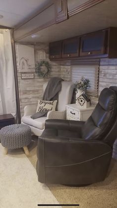 a living room with two recliners and a footstool in the corner