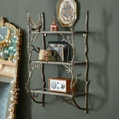 a shelf that has various items on it in front of a mirror and wall mounted clock