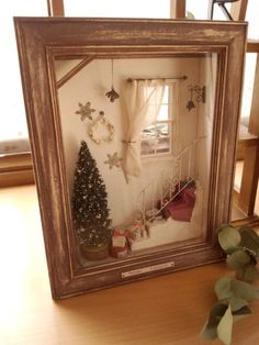 a christmas tree in a frame on a table