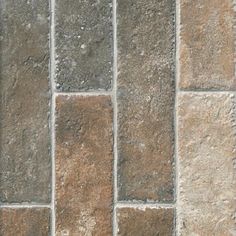 a close up view of a stone floor with different colors and shapes on it,