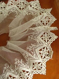 white lace is laying on top of a wooden table