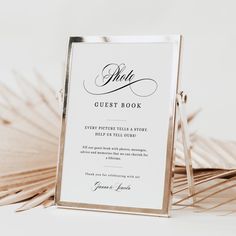 a wedding guest book with palm fronds in the background