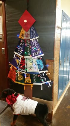 a christmas tree made out of t - shirts is displayed in an office cubicle