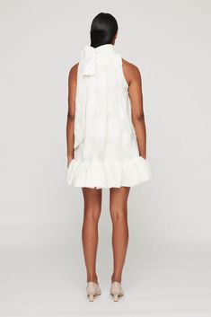 The Atticus Mini Dress features a high neckline with a bow detail that pairs perfectly with the short ruffled hem. The jacquard fabric elevates and provides depth to this mini dress! The Atticus is perfect for brides, as it is a charming silhouette with feminine details. 67% polyester, 26% cotton, 7% Nylon Lining: 100% cotton Dry clean only Fully lined Pull-on styling Midweight jacquard fabric with ruffle hem Fit runs oversized - we recommend sizing down for the Atticus Mini Dress. Adriana Degreas, Rebecca Vallance, Jenny Bird, Olympia Le Tan, Statement Dress, Atticus, Dress Silhouette, Knitwear Tops, Jacquard Fabric