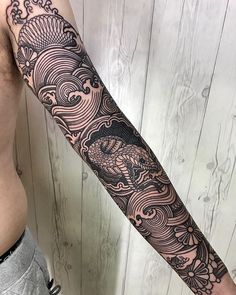 a man's arm with an intricate tattoo design on the left side of his body