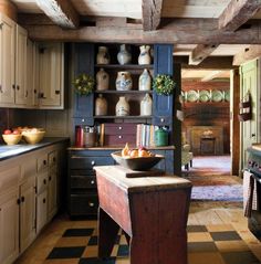 an old fashioned kitchen with black and white checkered flooring