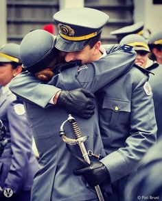 two people in uniform hugging each other