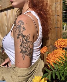 a woman with a flower tattoo on her arm