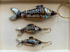 These antique articulated enamel cloisonné koi fish pendant and earrings are a rare treasure. These are the most vibrant and beautiful colors I've seen on articulated Koi fish jewelry! In amazing condition. Pendant measures 3 1/2 inches long. Earrings measure 2 inches long. Fish-shaped Enamel Jewelry As A Gift, Fish-shaped Enamel Jewelry For Gifts, Enamel Fish-shaped Jewelry As Gift, Enamel Fish-shaped Jewelry For Gifts, Fish-shaped Enamel Jewelry Gift, Traditional Fish-shaped Jewelry Gift, Traditional Fish-shaped Jewelry For Gift, Articulated Fish, Fish Jewelry