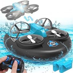 a hand holding a remote control flying toy in the water with four propellers and one propeller