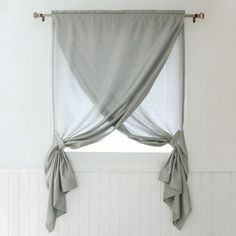 a window with some curtains hanging on it