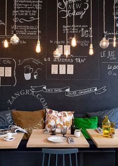 the restaurant is decorated with blackboard and white lights