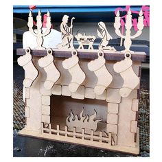 a wooden fireplace with christmas decorations on it