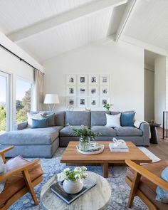 a living room filled with furniture and lots of windows