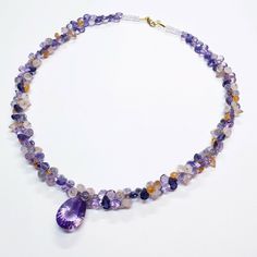 "DESCRIPTION: Thank you for coming in! A breath-takingly beautiful necklace made of an assortment of natural gemstones! You can find Iolite, Amethyst, sunstone and peach moonstone in this one necklace! Premium quality gemstones finished with gold filled headpins and 18k solid yellow gold clasp! 17\" gorgeous necklace, 186.9 carats! You'll get the necklace you see! SIZE: 14.7mmx23.5mm center stone. GRADE: Transparent COLOR: Multi" Purple Multi-stone Necklace Gift, Formal Amethyst Multi-stone Necklace, Purple Briolette Faceted Necklace, Elegant Purple Multi-stone Necklaces, Purple Multi-stone Pendant Gemstones, Cluster Necklace, Peach Moonstone, Sky Blue Topaz, Beautiful Necklace