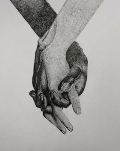 two hands holding each other with their fingers