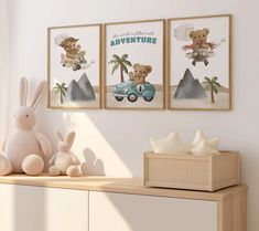 two framed pictures on the wall above a dresser with a stuffed bunny and teddy bear