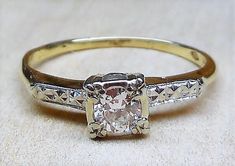 an antique diamond ring is shown on a white surface