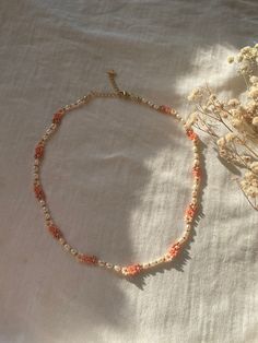 A handmade and beautiful pearl necklace made of flowers and freshwater pearls. This bracelet also goes great with it! https://www.etsy.com/de/listing/1423157681/handgemachte-perlenarmbander-aus DESCRIPTION: Discover our handmade pearl necklace "ROSÉ", which combines the delicate beauty of freshwater pearls with playful flowers. This unique necklace emphasizes your natural beauty and lets your inner radiance shine. Each bead tells a story of uniqueness and loving craftsmanship, while the delicate Handmade Dainty Pearl Necklace, Dainty Pearl Necklace With Colorful Beads, Cute Pearl Necklace With Pearl Charm, Cute Pearl Charm Necklace, Handmade Feminine Flower Necklace, Feminine Handmade Flower Necklace, Cute Pearl Jewelry With Colorful Beads, Cute Pearl Round Bead Necklaces, Handmade Pink Pearl Necklace