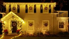 a house decorated with christmas lights and wreaths