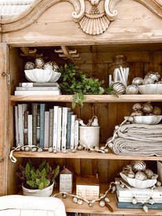 a book shelf filled with lots of books and other items on top of wooden shelves