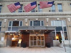 two american flags are flying in front of the hotel harlington, new york