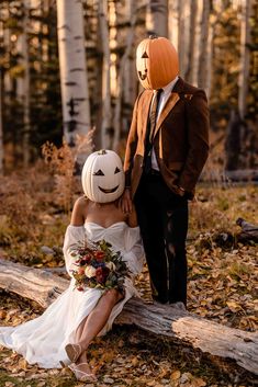 a man and woman dressed up as pumpkins