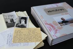 an open book sitting on top of a table next to papers and post it notes