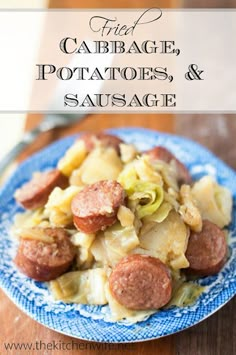 a blue plate topped with sausage and potatoes