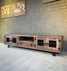 a large wooden entertainment center with metal handles