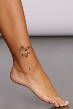 a woman's foot with a small tattoo on the side of her leg and ankle