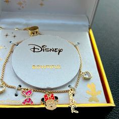 Disney Minnie Mouse Charm Bracelet , Iconic Face, The Word Beautiful, 2 Heart Shaped Crystal And A Pink Bow Makes Up The Dangling Charms. Pull Chains Adjust To A Comfortable Fit. Fine Silver Plated , Gold Tone Color. Disney Heart Shaped Jewelry Gift, Disney Heart-shaped Jewelry Gift, Gold Mickey Mouse Jewelry For Gift, Disney Jewelry For Valentine's Day Gift, Disney Style Jewelry For Valentine's Day Gift, Themed Jewelry For Disney Fan Events, Adjustable Disney Style Bracelets, Disney Style Pink Jewelry Gift, Pink Disney Jewelry For Gifts