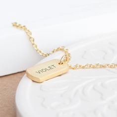 Whatever the occasion, make her feel extra-special with our sensational Personalised Gold Name Tag Necklace. It’s a truly one-of-a-kind accessory that she’ll wear out whenever she gets the chance and cherish forever. Whether you want to celebrate a birthday, commemorate a special anniversary or treat her to a Christmas surprise, this outstanding piece of jewellery allows you to add a sentimental touch that speaks straight to her heart. It’s also a perfect Valentine’s gift to show her how much she means to you in a timeless, elegant way. Attached to the gold chain comes a gold tag charm which can be personalised with her name. This will be meticulously etched by our dedicated team of engravers to the highest standard, creating an exceptional gift that’ll make a wonderful addition to her war Name Tag Necklace, Watch Locket, Gold Tag, Watch Cufflinks, Christmas Surprise, Jewelry Lockets, Childrens Jewelry, Layered Bracelets, Perfect Gift For Her