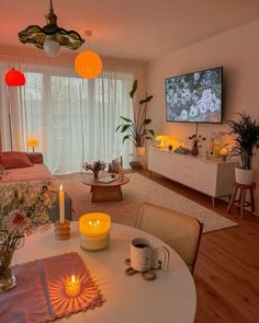 a living room filled with furniture and a flat screen tv mounted to the side of a wall