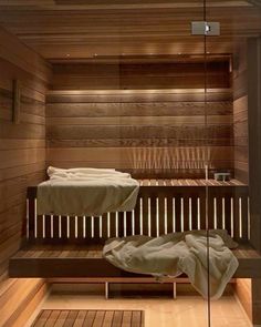 a wooden sauna with two beds in it