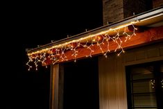 christmas lights are hanging on the outside of a house